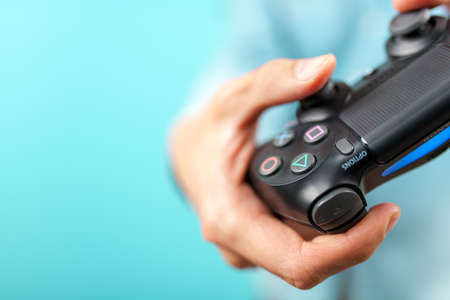 Male hands holding a PS4 controller