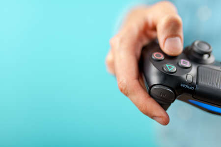 Male hands holding a PS4 controllerのeditorial素材