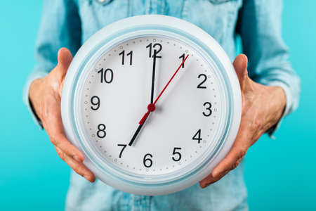 Man holding a clockの写真素材