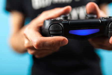 Male hands holding a PS4 controllerのeditorial素材