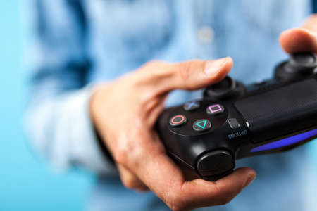 Male hands holding a PS4 controllerのeditorial素材