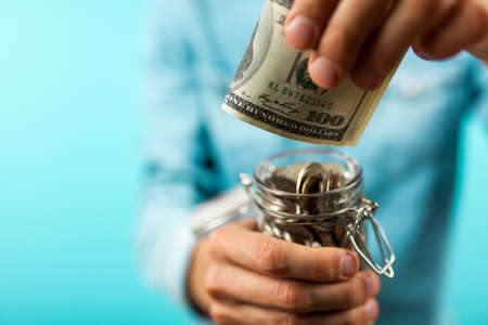 Man holding a coin jarの写真素材