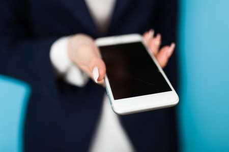 Female hand holding a phoneの写真素材