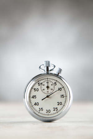 Analog stopwatch on grey background