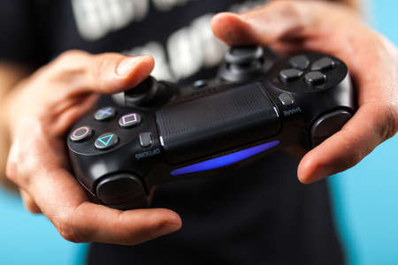 Male hands holding a PS4 controllerのeditorial素材