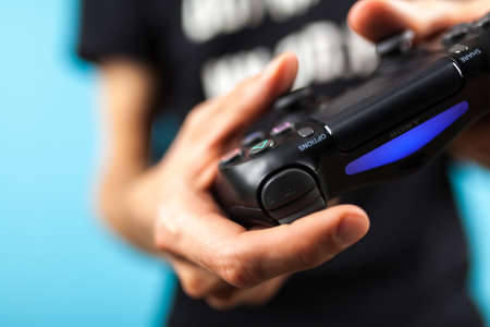 Male hands holding a PS4 controllerのeditorial素材
