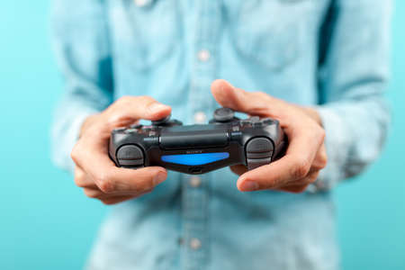 Male hands holding a PS4 controllerのeditorial素材