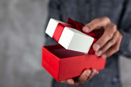 Man holding a present boxの写真素材