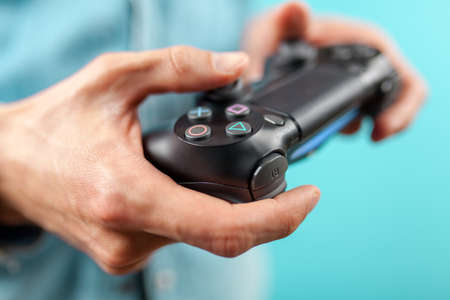 Male hands holding a PS4 controllerのeditorial素材