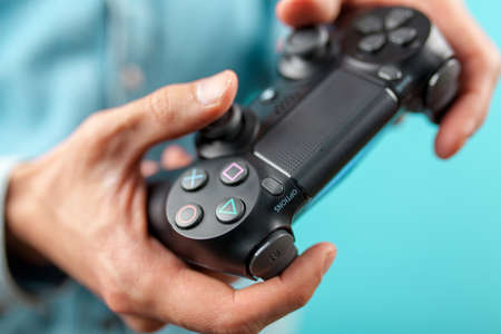 Male hands holding a PS4 controllerのeditorial素材