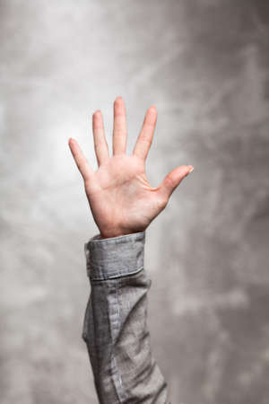 Female hand on dark backgroundの写真素材
