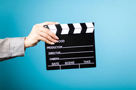 Female hands holding a clapperboardの写真素材