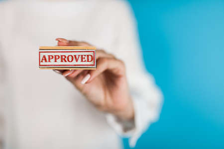 Woman holding Approved stampの写真素材