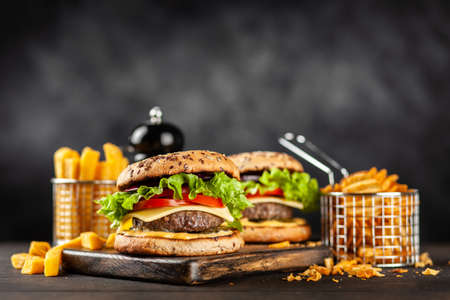 Delicious grilled hamburgers on dark background