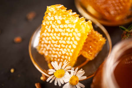 Honey jar and dipper with leaking honeyの写真素材