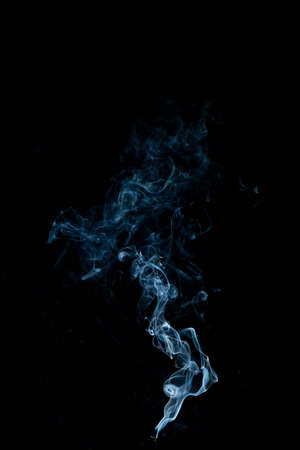 White smoke swirls on black backgroundの写真素材