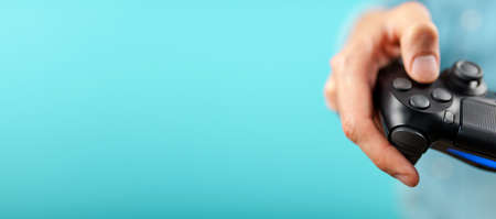 Male hands holding a gaming controller