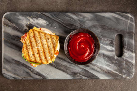 Tall club sandwich with eggs, turkey and baconの写真素材