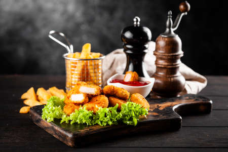 Crispy chicken nuggets with lettuce and ketchupの写真素材