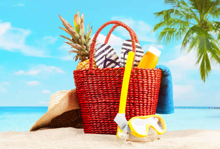 Red beach bag on blue beach and sky backgroundの写真素材