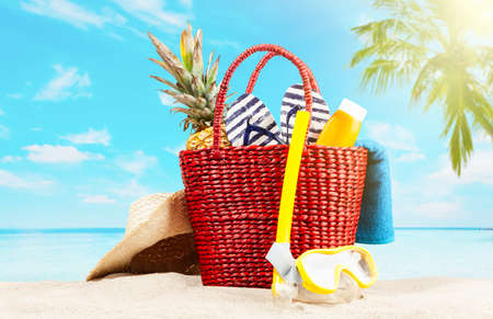 Red beach bag on blue beach and skyの写真素材