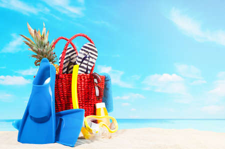 Red beach bag on blue beach and skyの写真素材