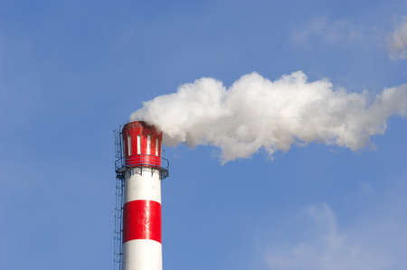 a smoky chimney in blue sky.の写真素材