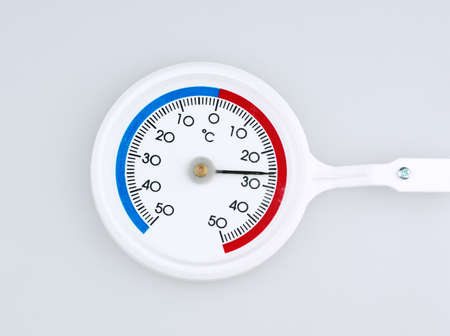 Closeup of circular thermometer on gray backgroundの写真素材