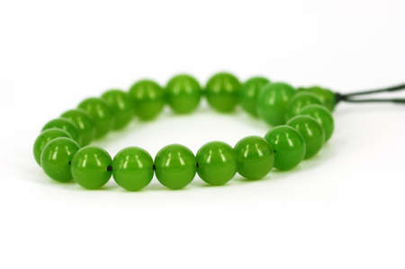 String of beads of green in white backgroundの写真素材