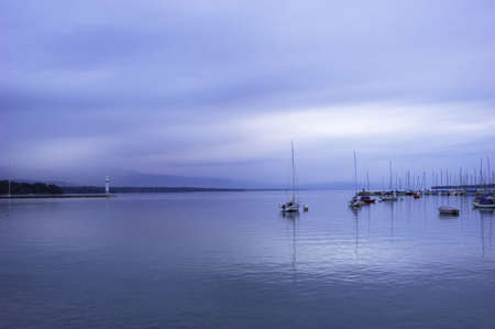 Quiet sailboat lough in the morning, geneva lake, switzerland.の写真素材