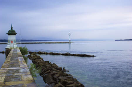 Tranquility lough with two pharos in the morning, geneva lake, switzerland.の写真素材