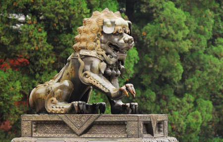 Bronze lion near the door to Xianshan Park in Beijing の写真素材