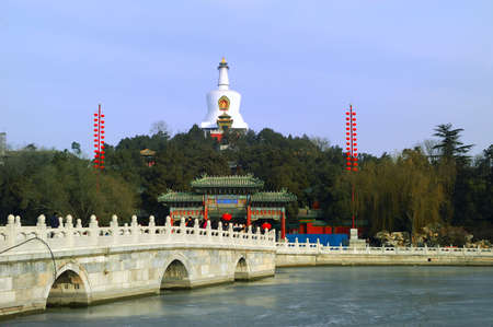 The park of the North Sea of the winter is in Peking, white tower and stone bridgeの写真素材