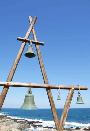 some bells hanging the rack at seasideの写真素材