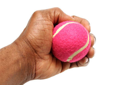 Hand gripping pink tennis ball の写真素材