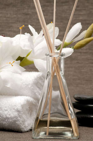 Aromatherapy diffuser, towels, stones and flower