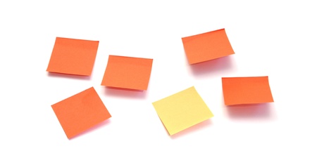 five orange post it surrounding a yellow one on a white background