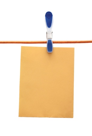 cloth peg holding a paper sheetの写真素材