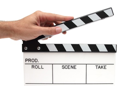 top of a movie claper with man hand holding itの写真素材