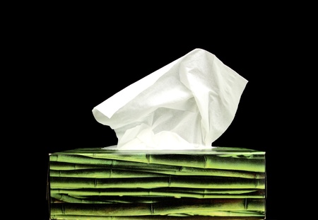 a green paper tissue box on a black backgroundの写真素材