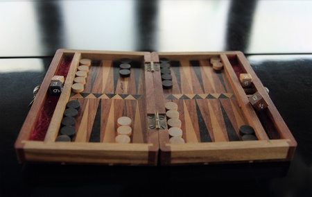 old wood backgammon on a reflecting table