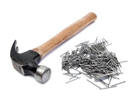 hand hammer with pile of nails over whiteの写真素材
