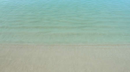 closeup of a calm blue sea taken from the beachの写真素材