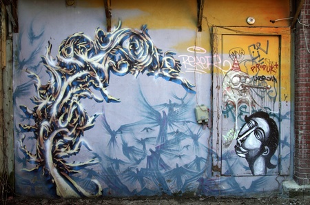 image of a wall and a door with colorful graffiti al overのeditorial素材