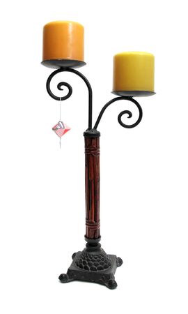 image of a candle holder with two large candles over whiteの写真素材