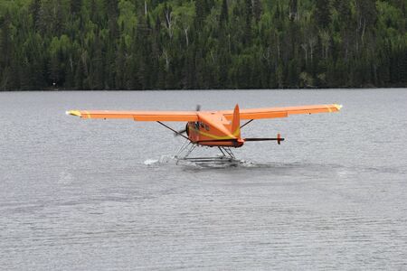 orange plane on a wild lakeの写真素材