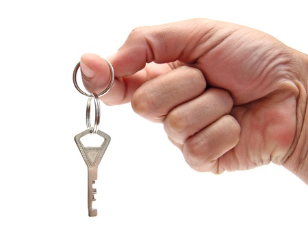 closeup of a hand holding a key ring with a single keyの写真素材