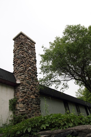 closeup oh a house with a old stone chimneyの写真素材