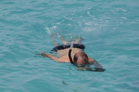 closeup of a snorkeler swimming in a lagoonの写真素材