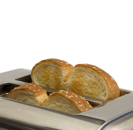 closeup of a metal toaster with two toastの写真素材